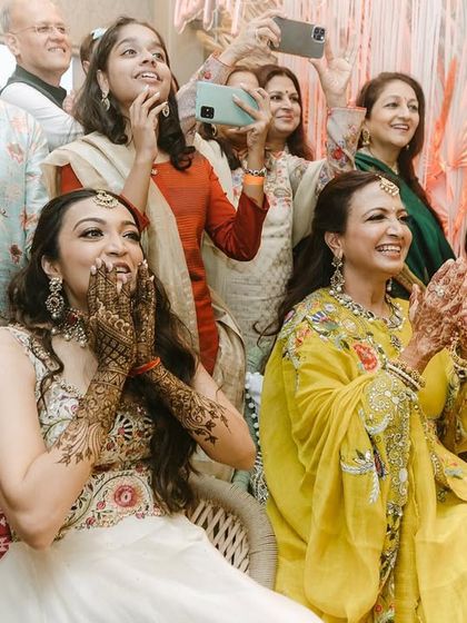 In an intimate wedding setting, every performance feels extra special. The bride's joyful reaction to her family's dance is a moment of pure, unscripted happiness.