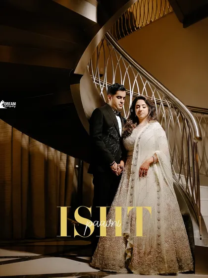 A grand portrait of Isht and Paavni on a spiral staircase, their names elegantly overlaid, capturing the luxury of their Dubai wedding.