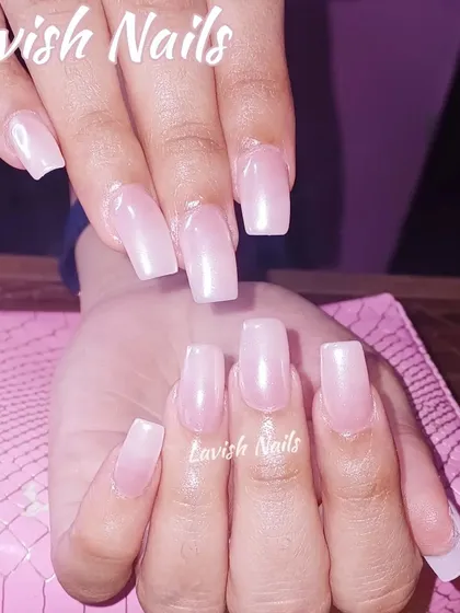 A clean and simple set of long, square-shaped nails with a sheer, natural pink overlay.