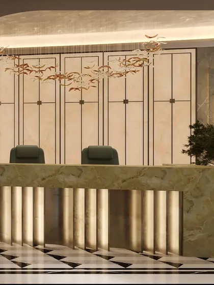 The reception desk, crafted from a single piece of green onyx, stands as a functional sculpture. Backlighting reveals the stone's natural veins, while the bespoke chandelier above mimics a flight of birds, adding a layer of organic artistry to the corporate environment.