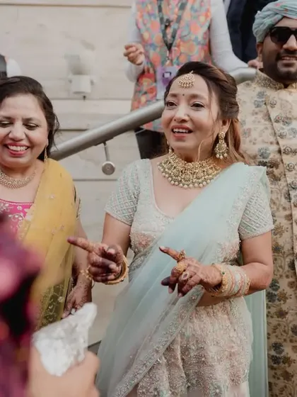 Family members dancing with joy in the baraat. It's a celebration for everyone.