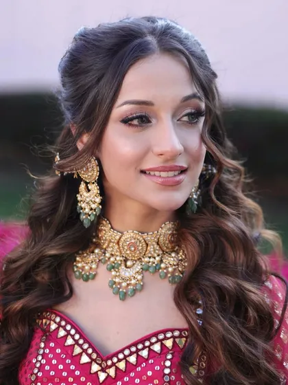 A close-up of the Bhaat ceremony look. Her skin is glowing, and the eye makeup is soft yet defined, perfectly complementing her intricate jewelry and outfit.