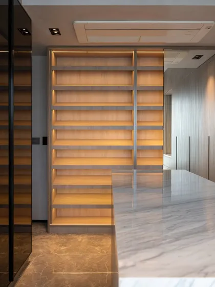 An empty, beautifully lit shelving unit in a walk-in closet, waiting to be filled. The warm, ambient lighting creates an inviting boutique-like feel, turning storage into a feature.