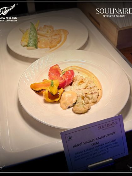 A plate of Hāngi-smoked Cauliflower Steak, a dish inspired by New Zealand's culinary traditions. We curate themed menus that pay homage to the event's cultural context.