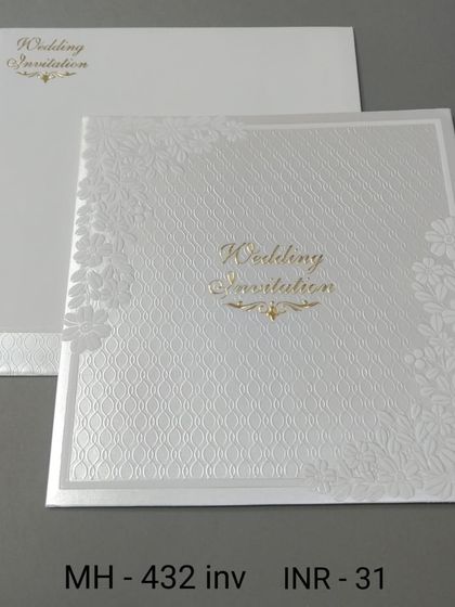 A square white invitation with a textured background and delicate floral laser-cutting on the corners. The gold script adds a touch of elegance to this affordable card.