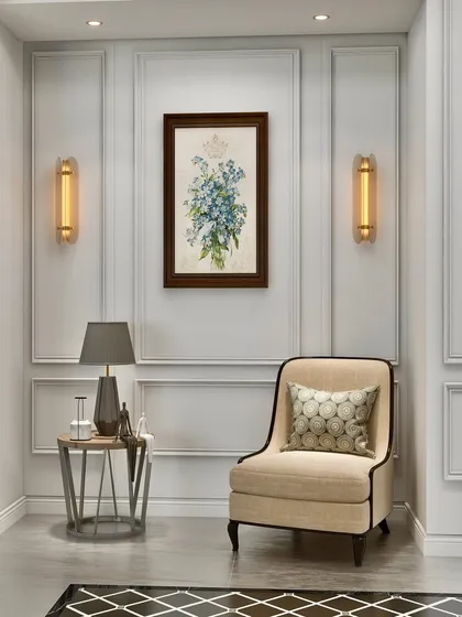A quiet corner designed for reflection. Classic wall molding, symmetrical sconce lighting, and a comfortable armchair create an intimate and elegant vignette.