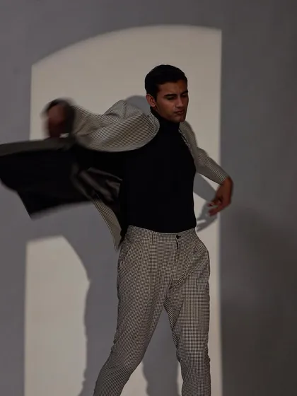This image captures the fluid motion of a lightweight suit, demonstrating a relaxed yet put together approach to modern menswear.