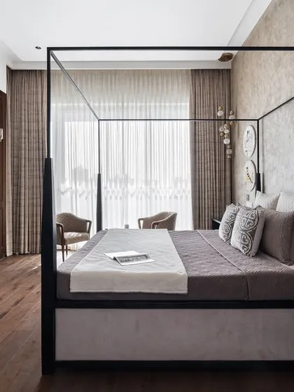 This master bedroom is designed as a serene retreat, blending modern and heritage styles. The four-poster bed creates a striking centerpiece, while the vintage writing desk and earthy textures add warmth and character, making it a truly personal sanctuary.