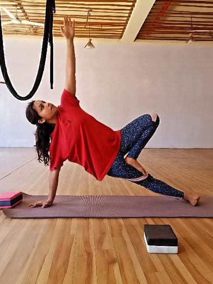 A student demonstrates a variation of Vasisthasana (Side Plank Pose), a challenging asana that builds incredible arm, shoulder, and core strength.