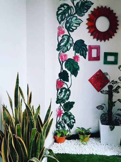 A creative touch for a small space. This hand-painted vine mural adds a permanent artistic and botanical element to the wall.