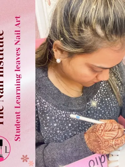This student, with beautiful henna on her hands, is practicing her nail art skills on a practice wheel.