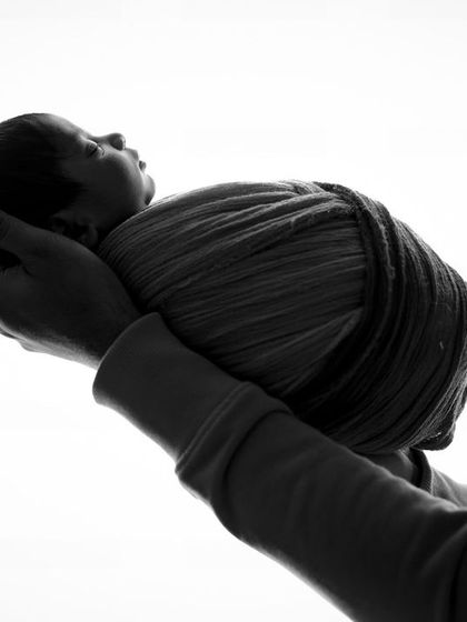 A precious gift. This simple, powerful black and white image of a baby being held in loving hands is a timeless representation of new life.