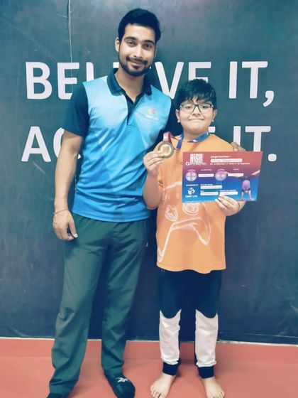 This student proudly displays his medal and certificate, a double achievement.