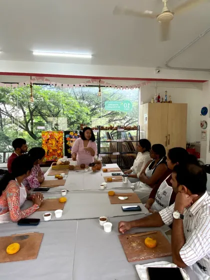 An instructor demonstrates a technique to a group of attentive students during a pottery workshop. I provide hands-on guidance to ensure everyone feels confident.