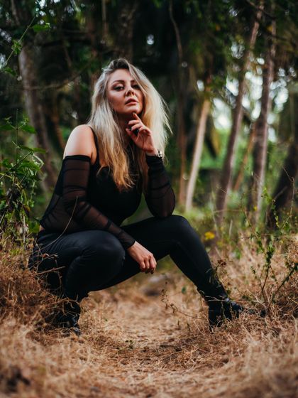 A thoughtful pose from the same outdoor shoot. The natural environment provides a moment of calm and reflection amidst a busy touring schedule.