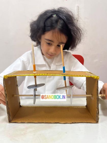 This student is testing the movement of her handmade machine. Our goal is to empower kids to see themselves as creators and problem-solvers through these hands-on engineering projects.