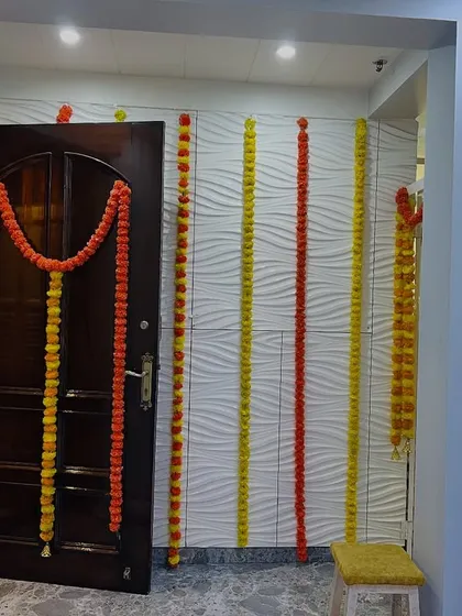 Simple and traditional door decoration using marigold garlands. This is a classic way to add a festive touch to your home for any pooja or wedding function.