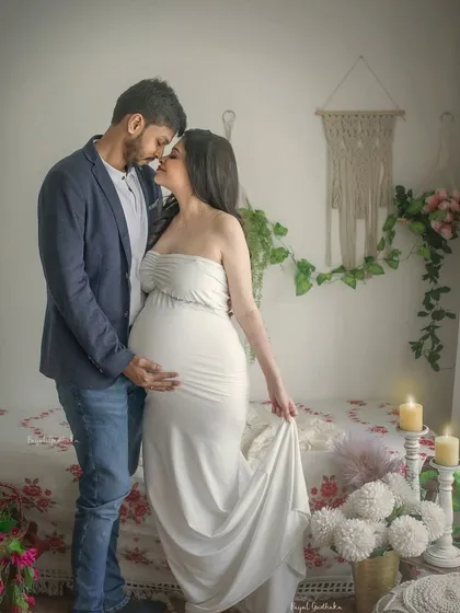 A romantic and classic pose, with the couple about to share a kiss. The simple white gown and the soft, natural lighting of the boho studio make this a timeless and beautiful image.