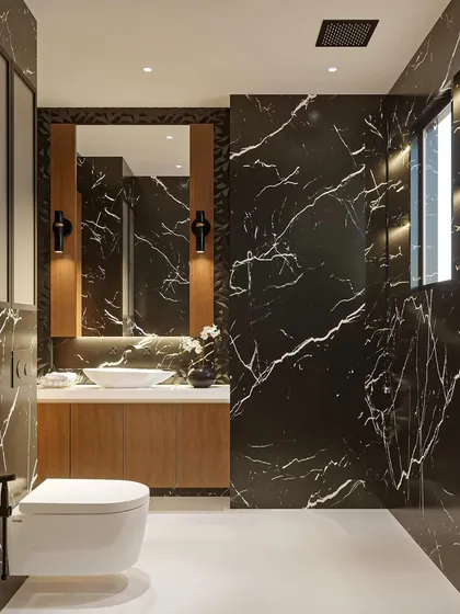 I believe bathrooms should be as luxurious as any other room. This design uses dramatic black marble with striking white veins, paired with warm wood and soft lighting to create a bold, spa-like escape.