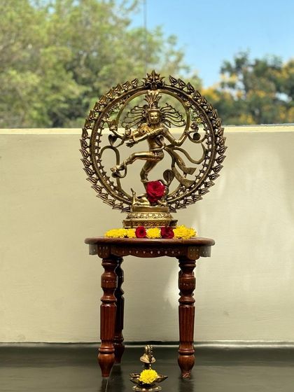 The Nataraja idol with a small lamp at its base, representing the light of knowledge and art.