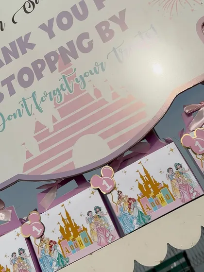 Personalized return gift boxes for a Disney Princess first birthday. These little details make guests feel appreciated.