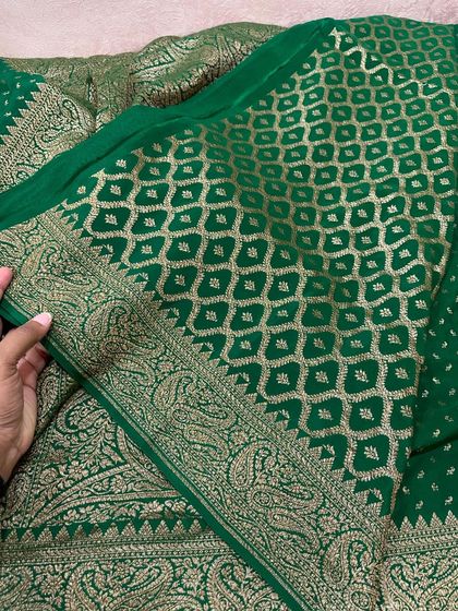 Another view of the bottle green saree, highlighting the diamond-patterned jaal on the pallu and the paisley border.