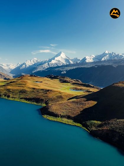 The incredible blue of a high-altitude lake against the backdrop of snow-capped peaks in the Spiti region. This is the kind of view that stays with you forever.