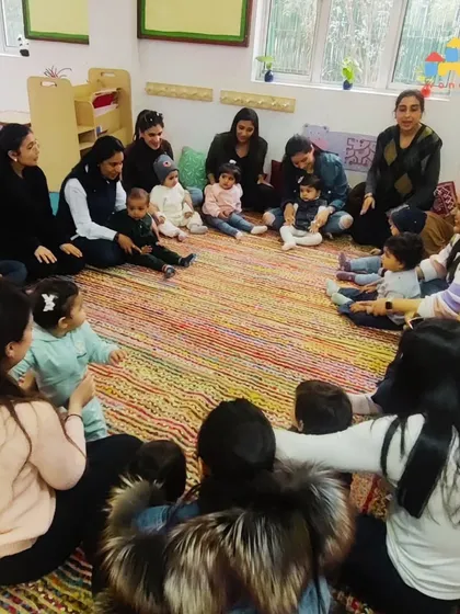 Circle time is a cornerstone of our Cuddle Bugs program. It's a time for songs, gentle movements, and social interaction, helping the littlest ones get comfortable in a group setting with their parent right beside them.