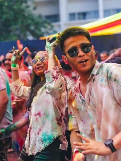 Friends dancing together, making memories at a color festival. I provide the soundtrack for these moments.