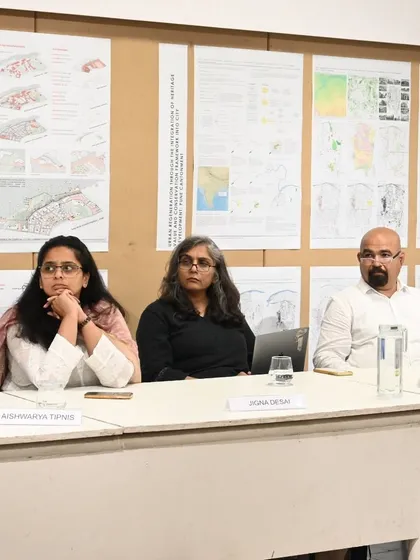Seated on a panel discussion with fellow experts. These academic engagements are vital for exchanging ideas and pushing the boundaries of current thought in urban conservation and design.