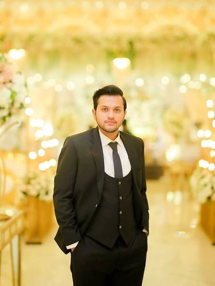 A close up portrait of the same client. The natural makeup ensures his skin looks clear and even, while his hair is styled to stay in place all evening.