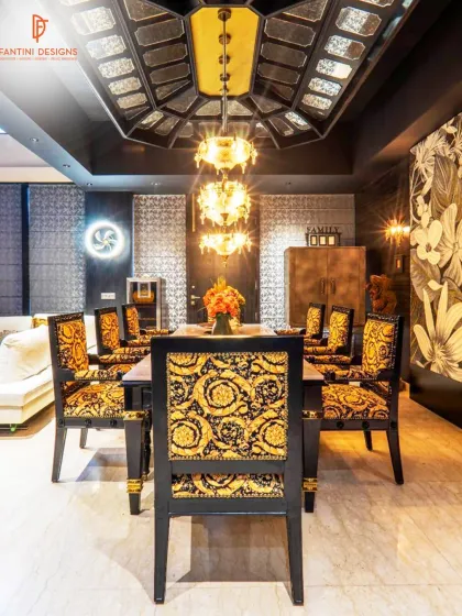 A closer look at the bold dining area from our luxury project. The Versace fabric chairs and custom ceiling with an antique chandelier make every meal feel special.