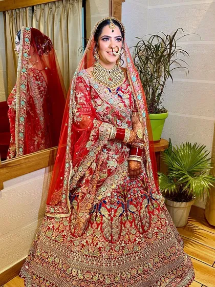 A beautiful and pink bridal look for my client from the US. The makeup features soft pink tones on the eyes and lips to match her intricately embroidered lehenga.