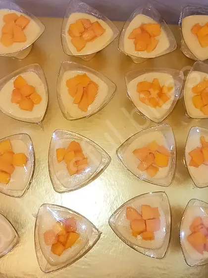 My Mango Soufflé Shots, served in individual triangular cups and topped with fresh mango chunks. A light, airy, and refreshing seasonal dessert.