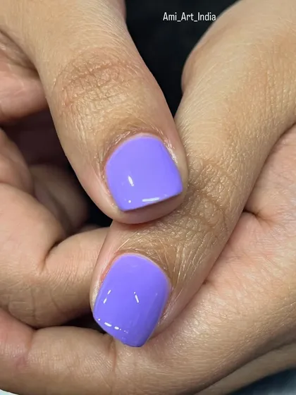 A close-up of the solid purple nails from the floral set.