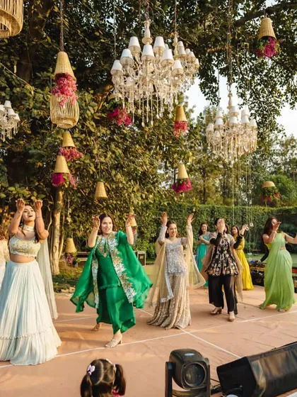 The bride and her friends enjoying a dance at their outdoor mehendi, with beautiful, natural choreography.