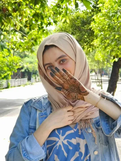A rare photo of the artist with her art! This was taken during a trip to Chennai where I couldn't resist doing some henna on myself.