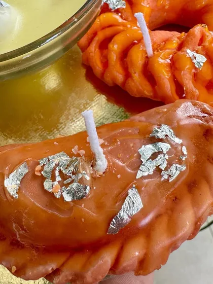 My Gujiya candle, shaped and glazed to look just like the real festive treat, but with a wick to light up your celebration.