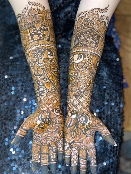This bridal design is filled with traditional peacock motifs. The feathers and intricate details cover the hands and arms for a classic and elegant look.