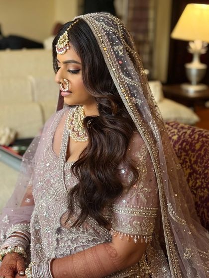 A side profile showing the complete look with the dupatta. You'll learn how to ensure the makeup and hair look perfect from all angles.