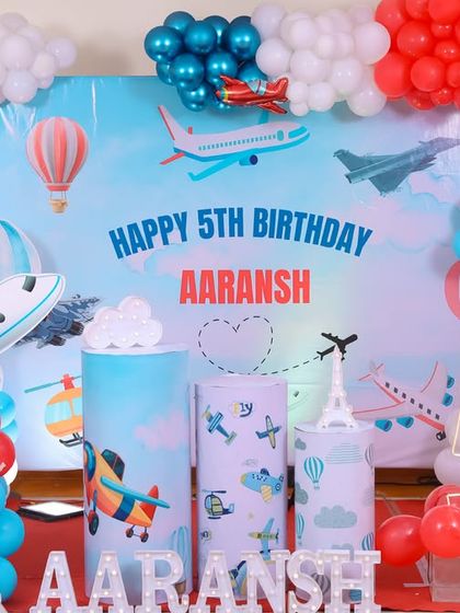A charming 'Baby Shark' themed birthday party, featuring a vibrant underwater backdrop, character cutouts of the shark family, and blue and yellow balloons, perfect for a fun-filled celebration.