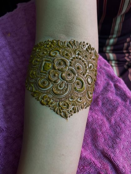 A close-up of the armband portion of the design. The details are incredibly fine, with delicate swirls and floral motifs.