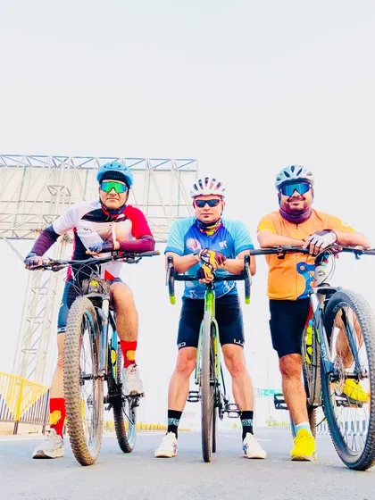 The trio of cyclists posing with their bikes. We are a team, on and off the road.