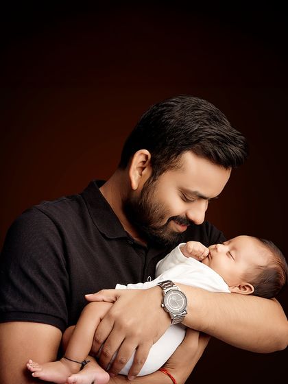 A quiet moment between father and newborn. These tender portraits capture the beginning of a beautiful bond that will last a lifetime.