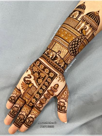 A full view of a minimal bridal design. The hands feature symmetrical patterns of elephants and peacocks, set against a backdrop of palace architecture.