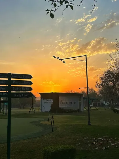 The directional sign points the way as the sun sets, casting a beautiful orange glow over the entire camp.