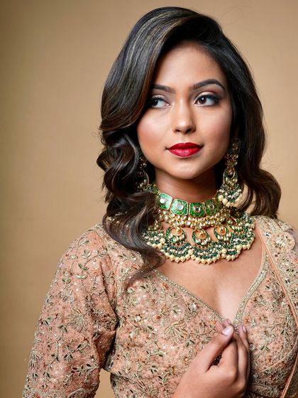 A classic bridal look with a red lip and winged liner. This timeless combination is a must-know for any aspiring bridal makeup artist.