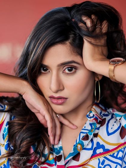 A lifestyle fashion shoot for an actress, featuring a colorful printed shirt and blue jeans. Shot in a modern cafe, these images have a bright, energetic, and youthful feel, perfect for a commercial or social media campaign.