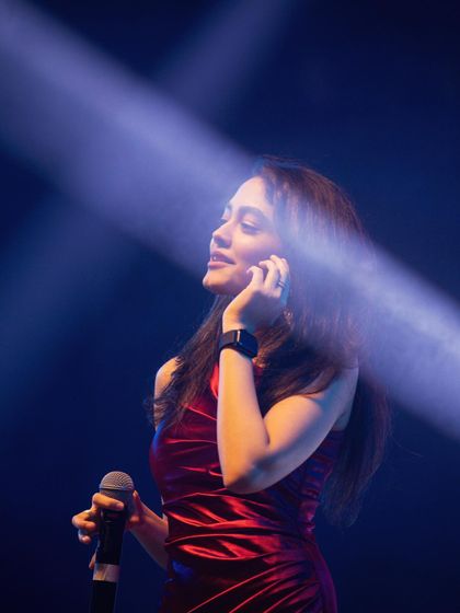Caught in the spotlight during a live concert. The right lighting and sound are key to a great performance, something my team and I always focus on.