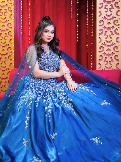 This royal blue ball gown with silver floral embroidery is a dream come true. The cape adds a touch of regal drama.
